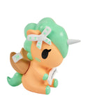 The Tokidoki Fortune Cookie Unicorno Blind Box features a small orange and green figure with a white horn, brown wings, and a scroll in its mouth—an adorable collectible surprise!.
