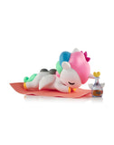 A Tokidoki Spa Day Unicorno from the Blind Box collection lounges peacefully on a cozy rug.