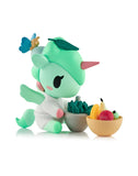 The Tokidoki Spa Day Unicorno Blind Box features a pastel green Unicorno with a pink horn, apron, and leaf hat, plus fruit bowls and a blue butterfly—an adorable wellness-themed collectible.