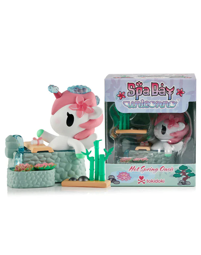 The Tokidoki Spa Day Unicorno - Hot Spring Oasis (Special Edition) figurine relaxes in a hot spring with bamboo and stones, shown next to its themed packaging.