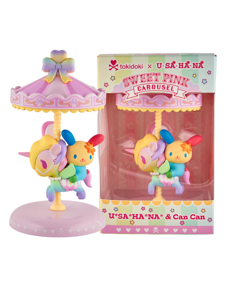 A pastel Sweet Pink Carousel figurine featuring U*SA*HA*NA sits beside its matching box, branded tokidoki x Hello Kitty and Friends—a delightful special edition collectible for fans.