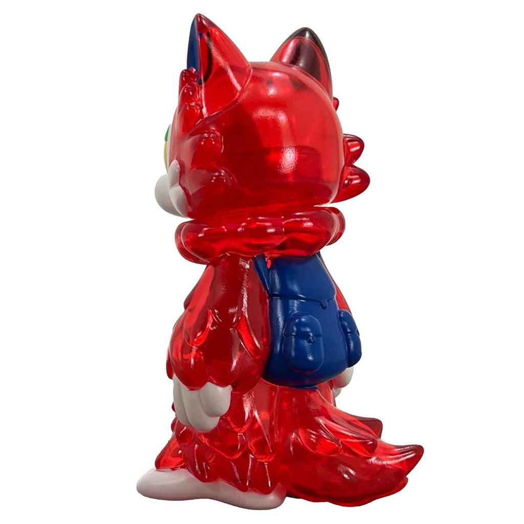 This transparent red and blue figurine of a fox, created by Japanese artist Wolf-Kun, is wearing a backpack.