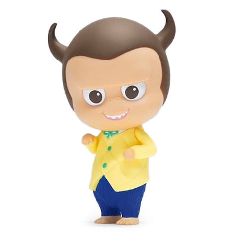 A small, cartoonish figure with horns, large eyes, and a mischievous grin, dressed in a yellow jacket, blue pants, and a green bow tie is the Yaya — Gemini by Rotofugi.