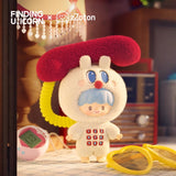 The zZoton — Happy Childhood Blind Box by Finding Unicorn features a blue-haired figure in a fluffy white suit with a red phone receiver hat, standing beside nostalgic items like a pink Tamagotchi, yellow glasses, and a vintage radio.
