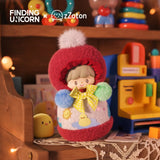 The Finding Unicorn zZoton — Happy Childhood Blind Box features a collectible figure with a red hood, yellow bow, and colorful pom-poms on a lace table. Toys, books, and cozy lighting set a nostalgic scene—ideal for collectors and fans alike.