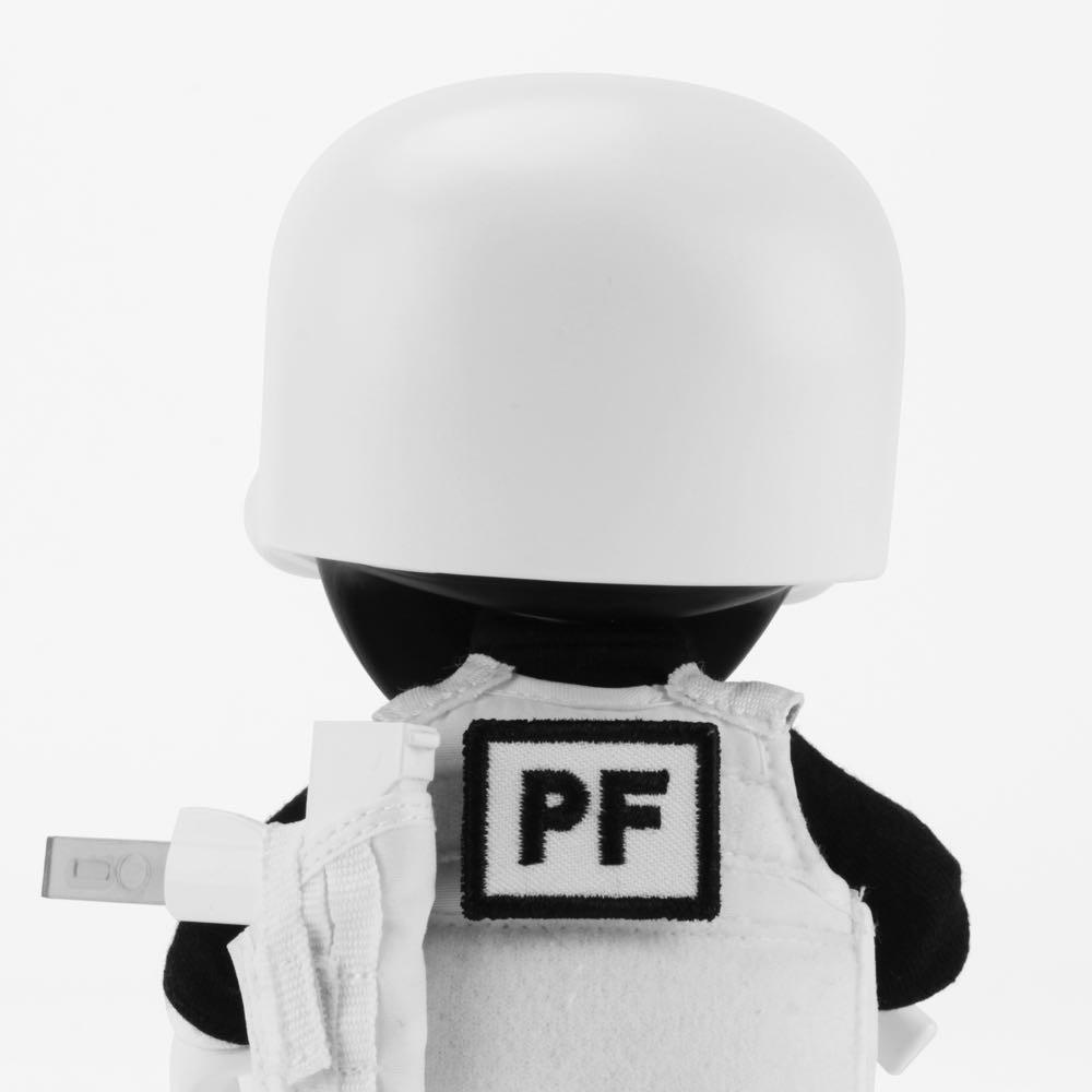 The Squadt NOZZEL S005 [PEACE F***ER] by Playge (HK/US) is a vinyl figure with a white helmet, white vest featuring a black 