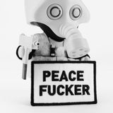 The Squadt NOZZEL S005 [PEACE F*ER] vinyl figure by Playge (HK/US) features a gas mask, holds a gun, and displays a bold “PEACE F*ER” patch—capturing the edgy spirit of the iconic shirt.