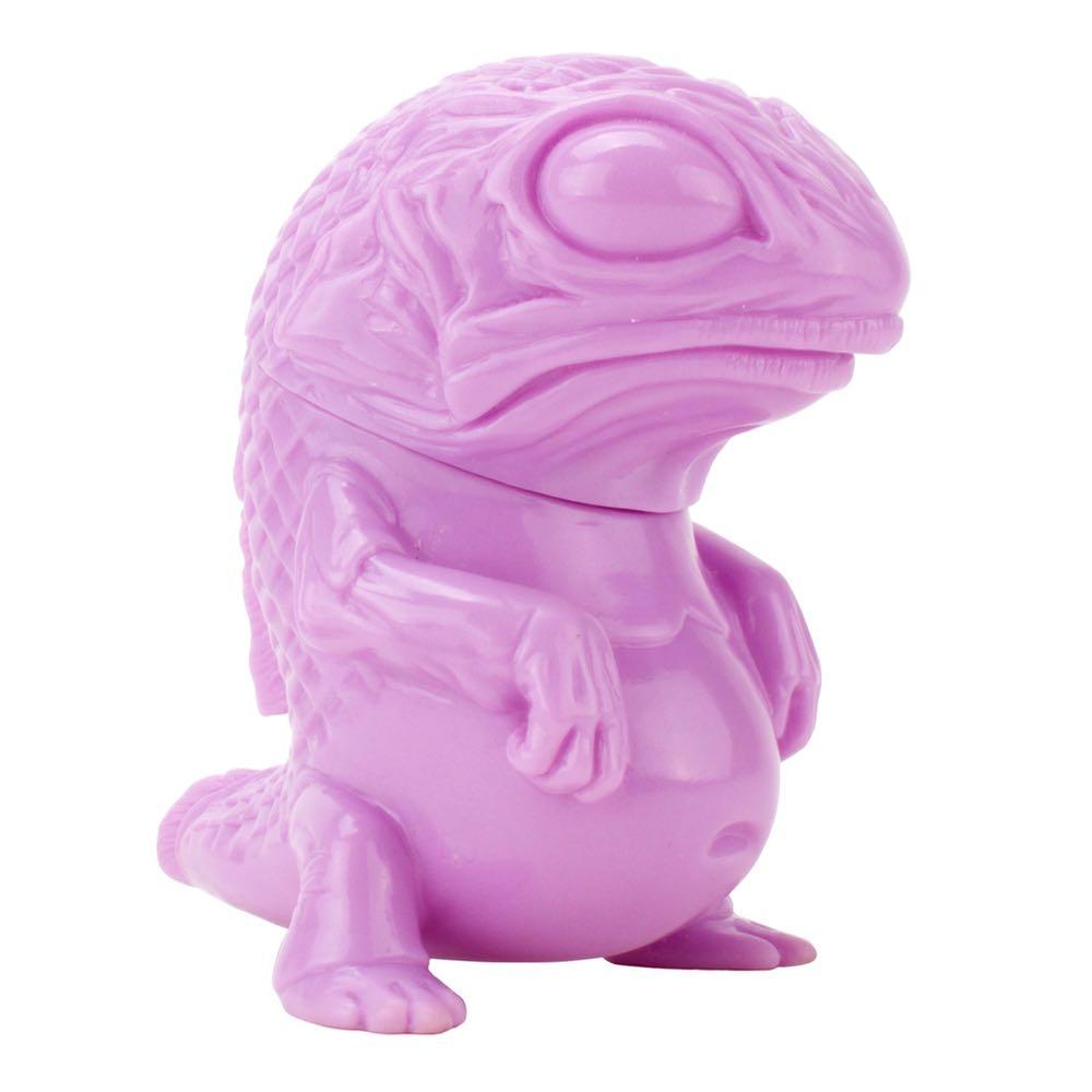 A pink Snybora toy lizard sits on a white background, freshly painted.