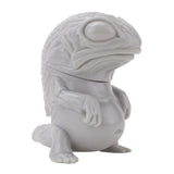 A Snybora DIY toy lizard is sitting on a white surface.