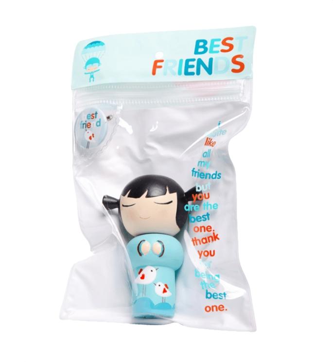 The Best Friends Momiji Doll by Momiji (UK) features a toy figure with closed eyes dressed in blue clothing, packed inside a clear bag adorned with 