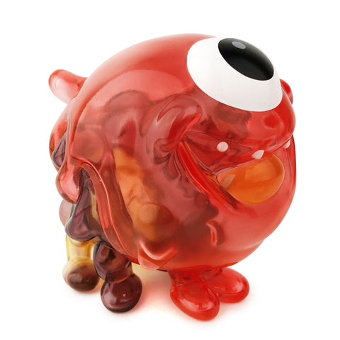 A red glass Gellog — Type-C from Strangecat Toys (US) with an eye on it.