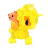 A yellow Tokidoki Unicorno Series X blind box with a teddy bear on its back.