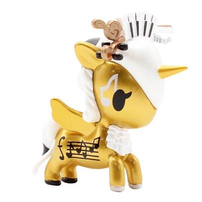 A gold Tokidoki Unicorno Series X Blind Box ornament with music notes.