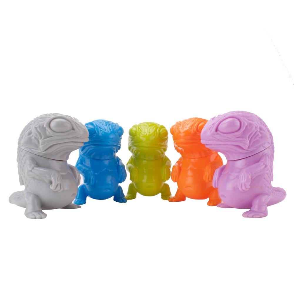 A row of brightly painted Snybora toy lizards by Squibbles Ink + Rotofugi.