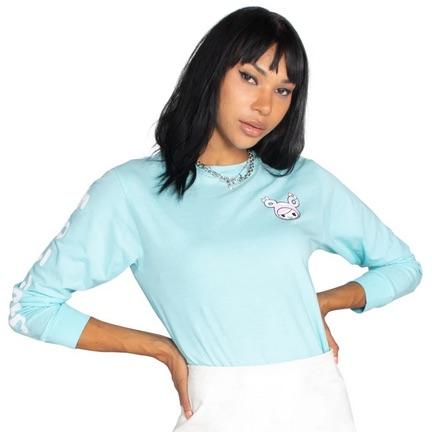A woman wearing a blue long sleeve tee and white skirt from the tokidoki Kawaii Life Unisex Long-Sleeve Tee collection.