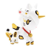 A white and gold figurine of a cow from the Tokidoki Unicorno Series X Blind Box by tokidoki.
