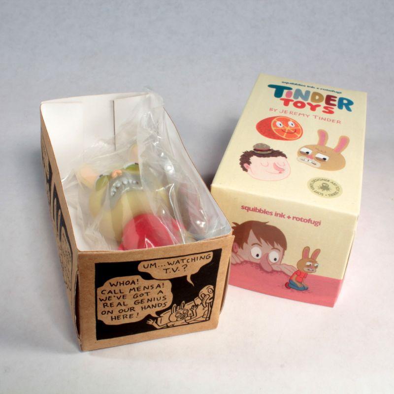 A toy box with a Tinder Toys: Rabburt bunny inside by Squibbles Ink + Rotofugi (US).