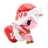 An adorable pink unicorn donning a santa hat, radiating holiday cheer from the tokidoki Holiday Unicorno Series 3 Blind Box.