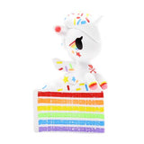 A dessert-themed Delicious Unicorno Blind Box with sprinkles on top of a cake by tokidoki.