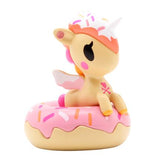 A dessert-themed toy unicorn perched on a donut, the Delicious Unicorno Blind Box by tokidoki.