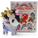 A small Unicorno Bambino Series 2 figurine from the tokidoki Blind Box in front of a blind box.
