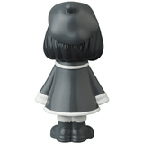 A black and white figurine of a girl wearing a hat, reminiscent of Japanese vinyl toy artists, like the VAG 31 — Uramy and Tsurami by Medicom (JP).