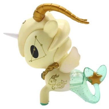 A white toy unicorn with a golden tail is a collectible Zodiac Unicorno — Capricorn by tokidoki.