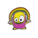 An enamel pin from The Artpin Collection featuring a yellow monster clutching a rainbow, created by artist Fleabaines.