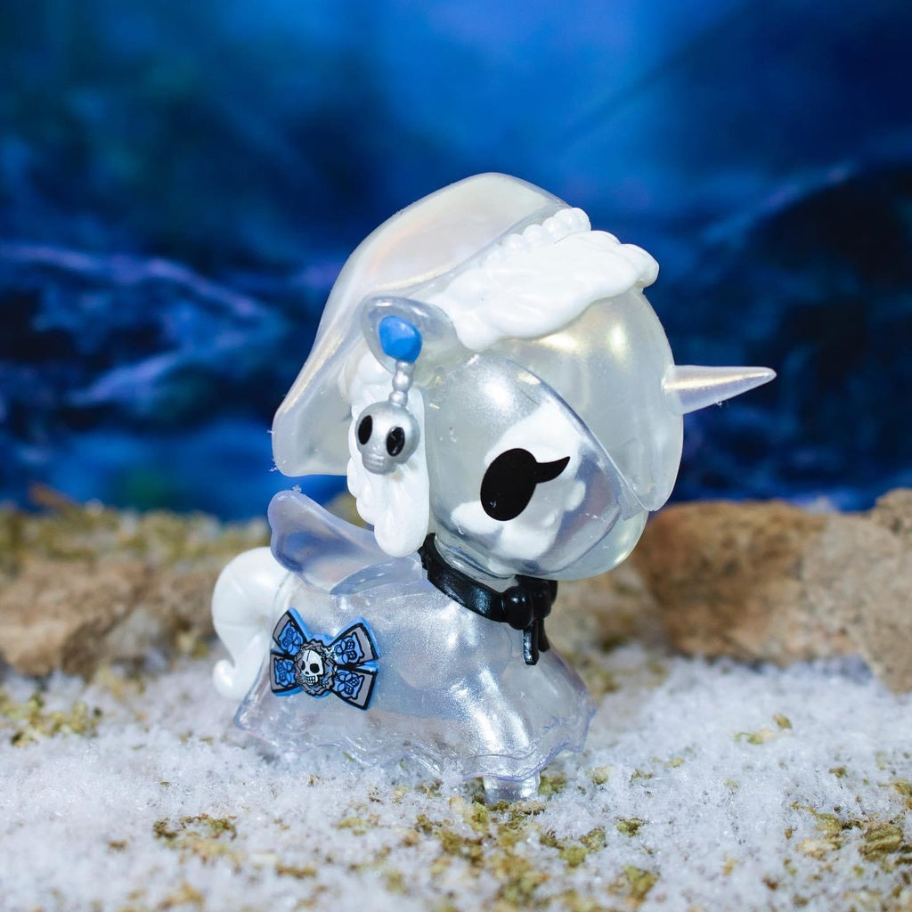 A tokidoki Unicorno After Dark Series 2 Blind Box with a hat on is sitting in the snow.