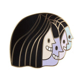 A black enamel pin featuring three women's faces designed by Nathan Jurevicius from The Artpin Collection - Junction by The Artpin Collection (IL).