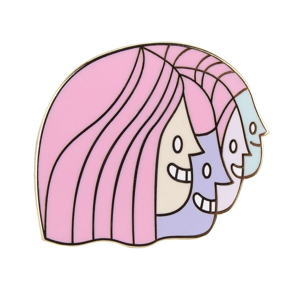 A pink and blue enamel pin featuring three faces by The Artpin Collection (IL) - Junction.