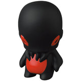 A black VAG Series 28 Kodakatsubon toy with red eyes and mouth created by Japanese vinyl toy artists Medicom.