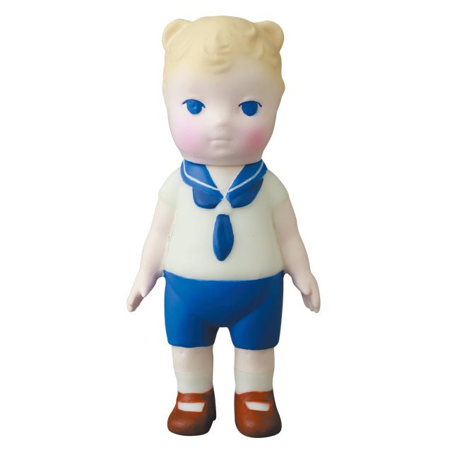 A blue and white figurine of a boy in a sailor's uniform, inspired by Japanese vinyl toy artists, VAG 30 — Kumamimichan from Medicom (JP).