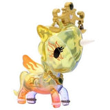 A toy unicorn wearing a golden crown, inspired by the Zodiac Unicorno — Libra from tokidoki.