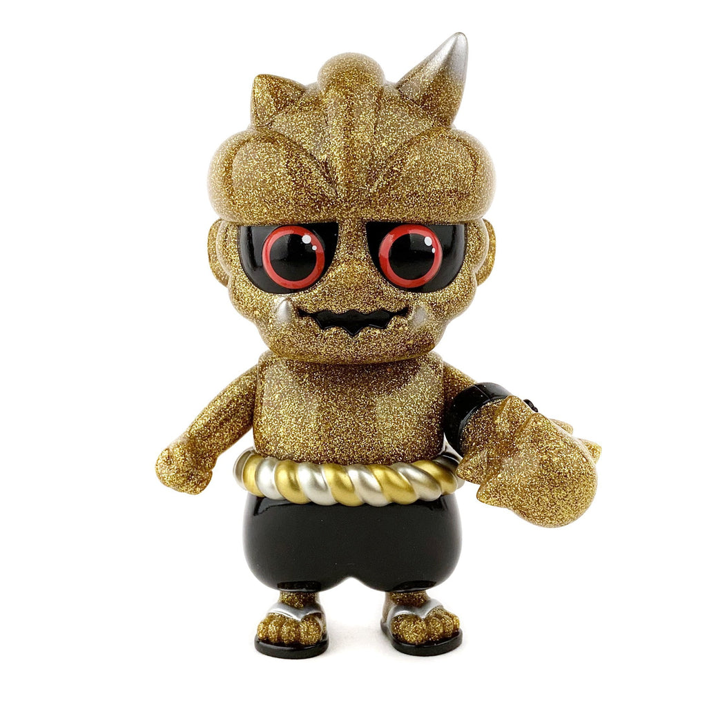 A Oniki (The Ninja Tribe) — Oma inspired gold figurine with red eyes and a black belt by How2Work (HK).
