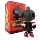 A limited edition vinyl figure of PumpKid in front of a box, perfect for Halloween enthusiasts and collectors of designer toys. Just released by Clutter Studios (US), it's the Collect or Die Edition by Czee13.