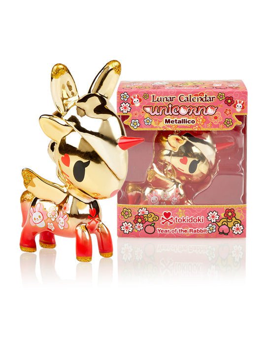 A limited edition Unicorno — Lunar Calendar Metallico Year of the Rabbit toy of a deer next to a box by tokidoki.