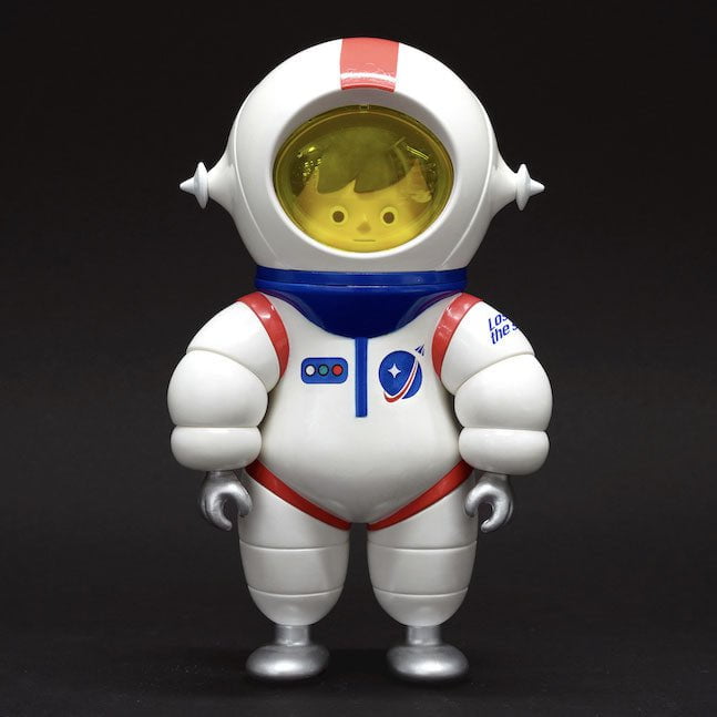 This artwork features a toy astronaut standing on a black background, created by Hong Kong-based artist How2Work (HK). The piece embraces a retro aesthetic.